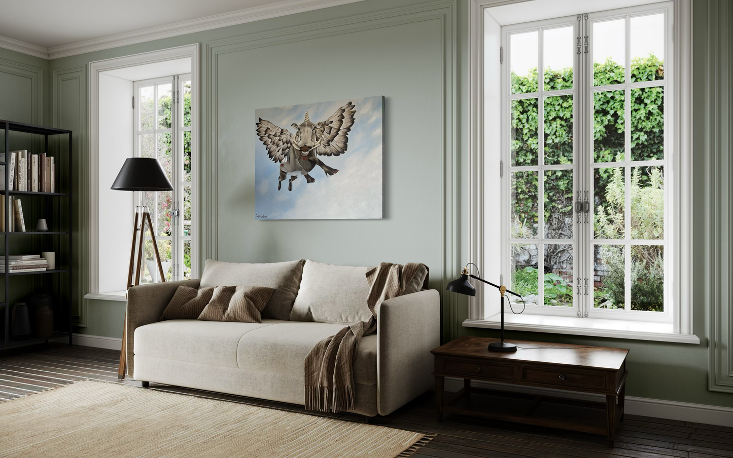 Living room with a beige sofa, lamp, and artwork of a flying bushpig or warthog on a light green wall.