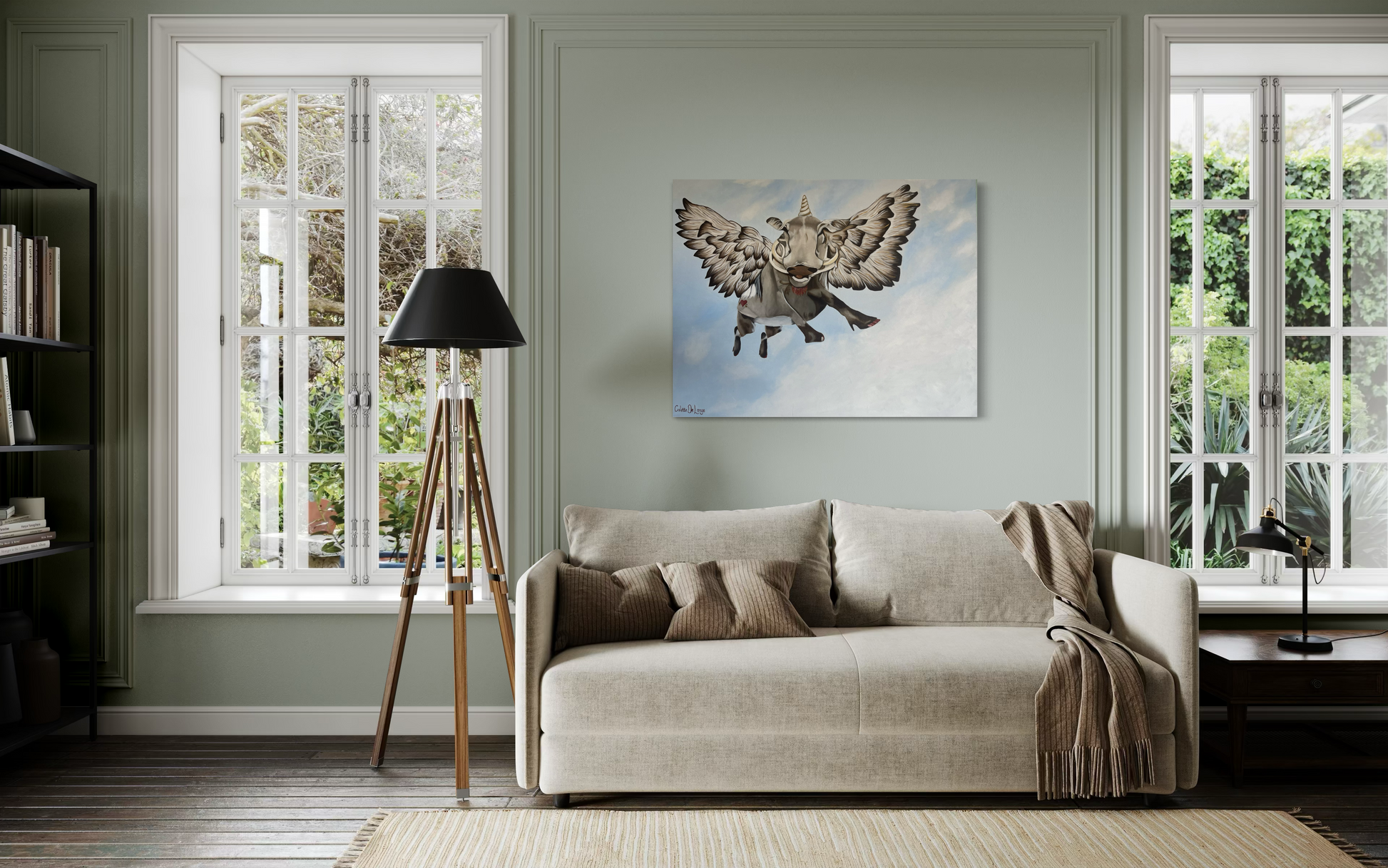 Living room with a beige sofa, lamp, and wall art of a flying bushpig or warthog