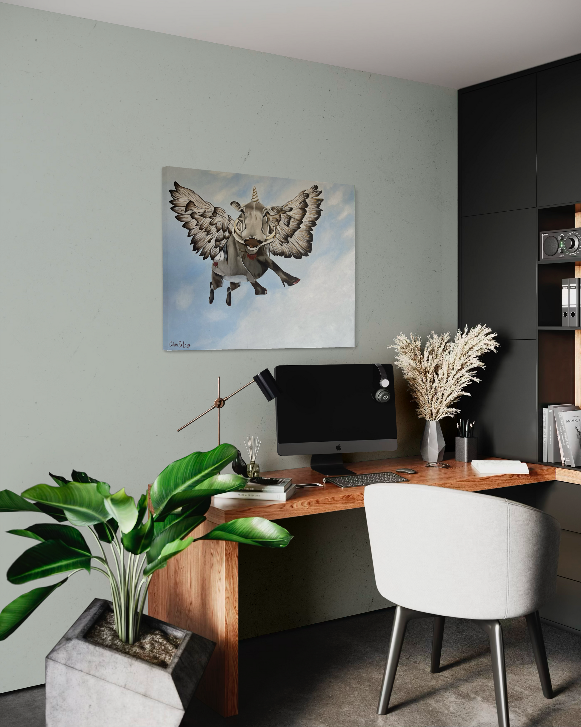 Modern home office with a desk, chair, computer monitor, and decorative elements with wall art of a flying bushpig or warthog.