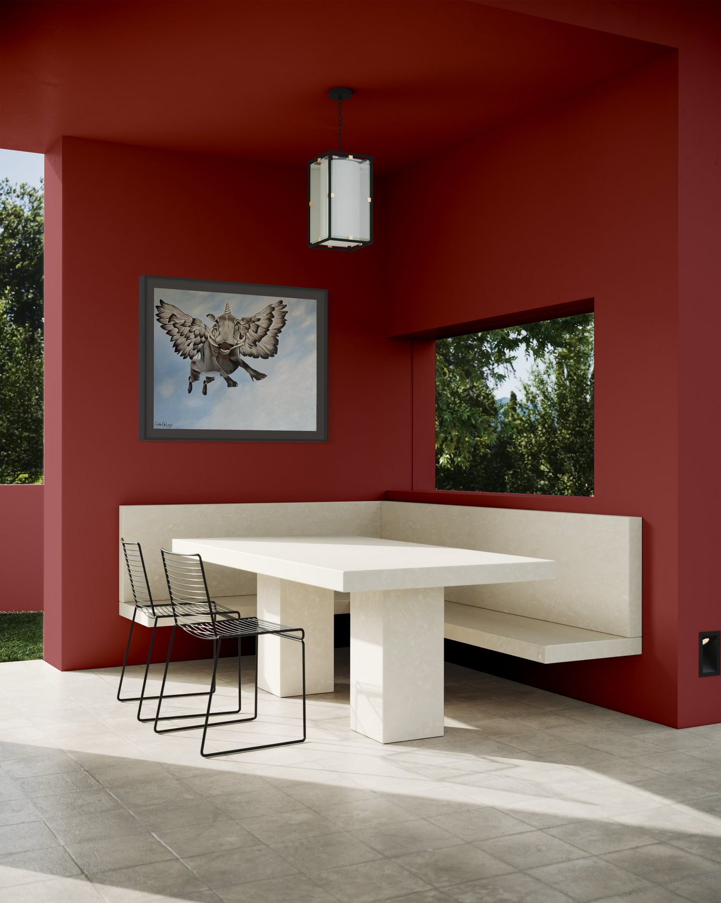 Modern dining area with a white table and bench against a red wall with wall art of a flying bushpig or warthog.